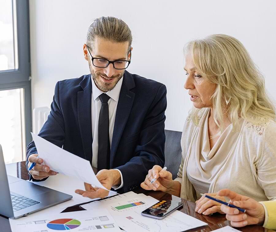 Adviser discussing business charts and documents with a client