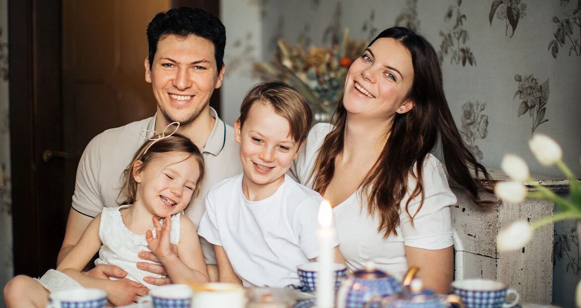 Happy young family together at a table at home